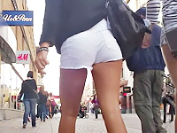 Pretty amateur chick is hurrying up somewhere pleasing the voyeur hunter with sexily moving ass under nice white shorts